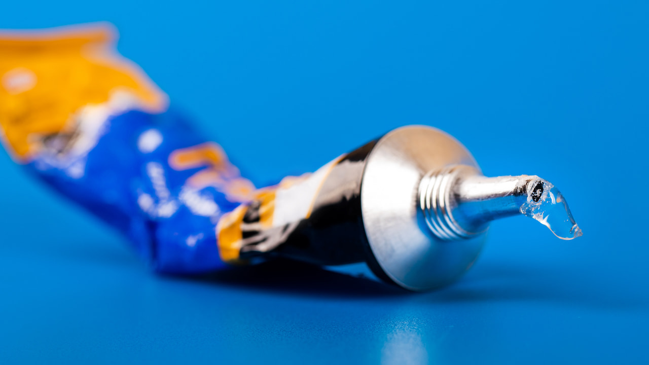 Super,Glue,Tube,On,Blue,Background