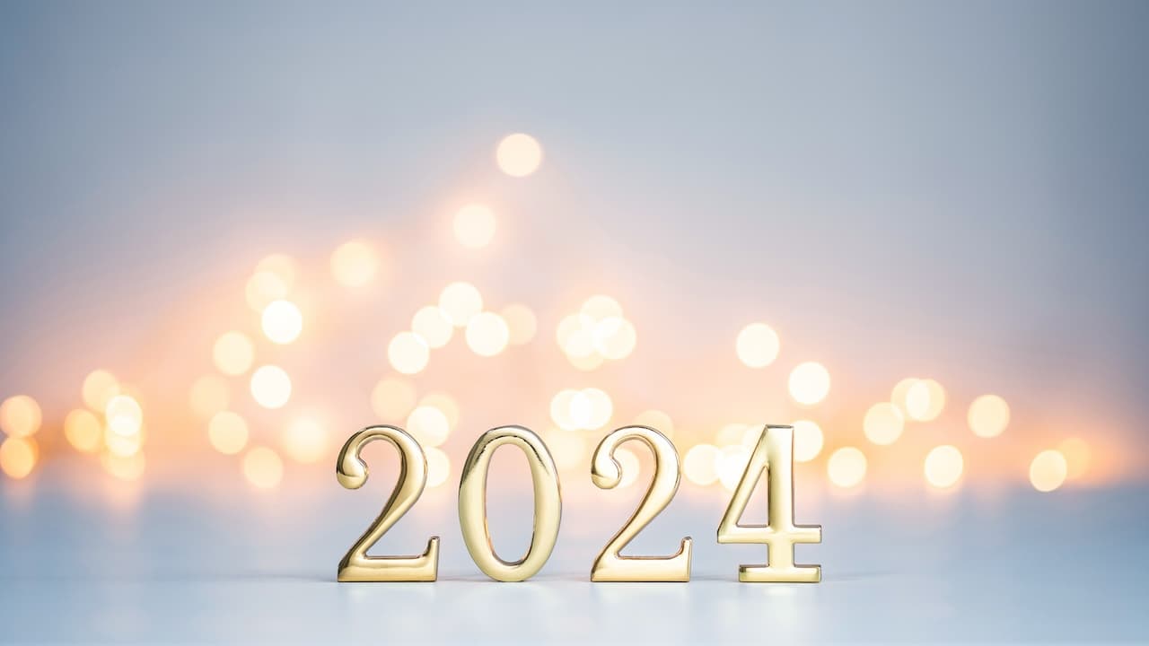 Golden digits in 2024 number with bokeh lights in the background. 2024 new year backdrop. Light and soft